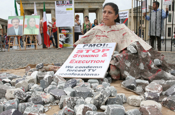 A woman protests stoning at a demonstration in Berlin